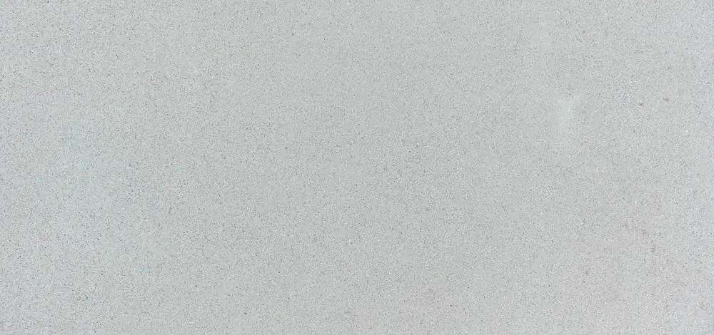 A smooth light grey concrete surface with a fine granular texture